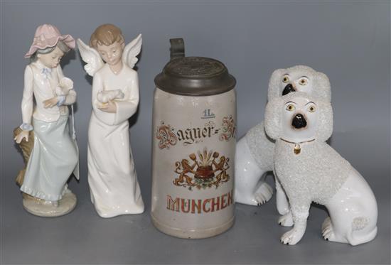 Two Nao figures and a pair of Staffordshire dogs and a beer stein